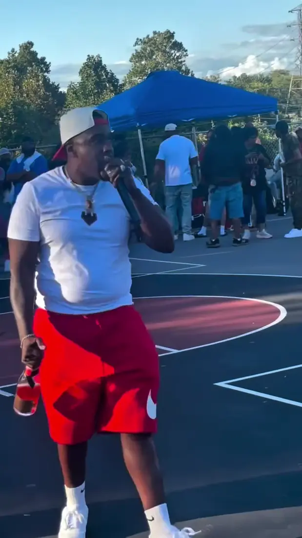 Host on the mic on the outdoor court at the Legends Only streetball tournament, event coverage by Pixel Perfect Visuals