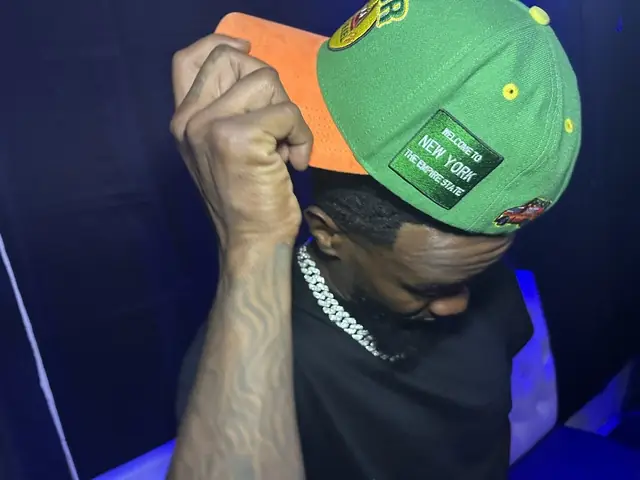 BSF Tone 066 in a green New York snapback under blue stage light, artist portrait by Pixel Perfect Visuals