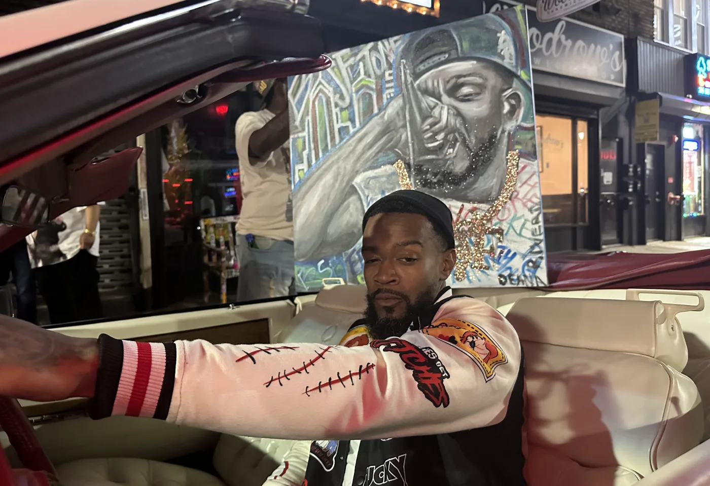 Night portrait with a hand painted canvas artwork on a city street — entertainment content by 066 Media