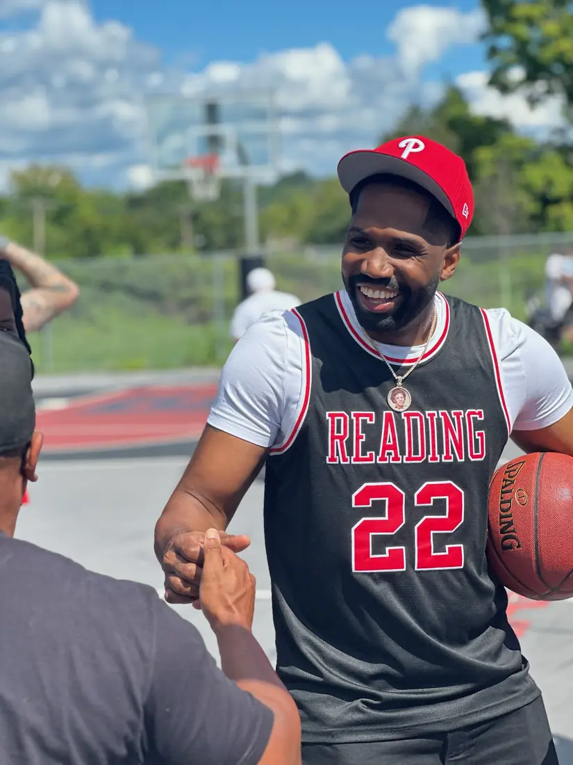 Player in a Reading 22 jersey shaking hands courtside at the 2nd Annual Legends Only Basketball Tournament, event coverage by Pixel Perfect Visuals