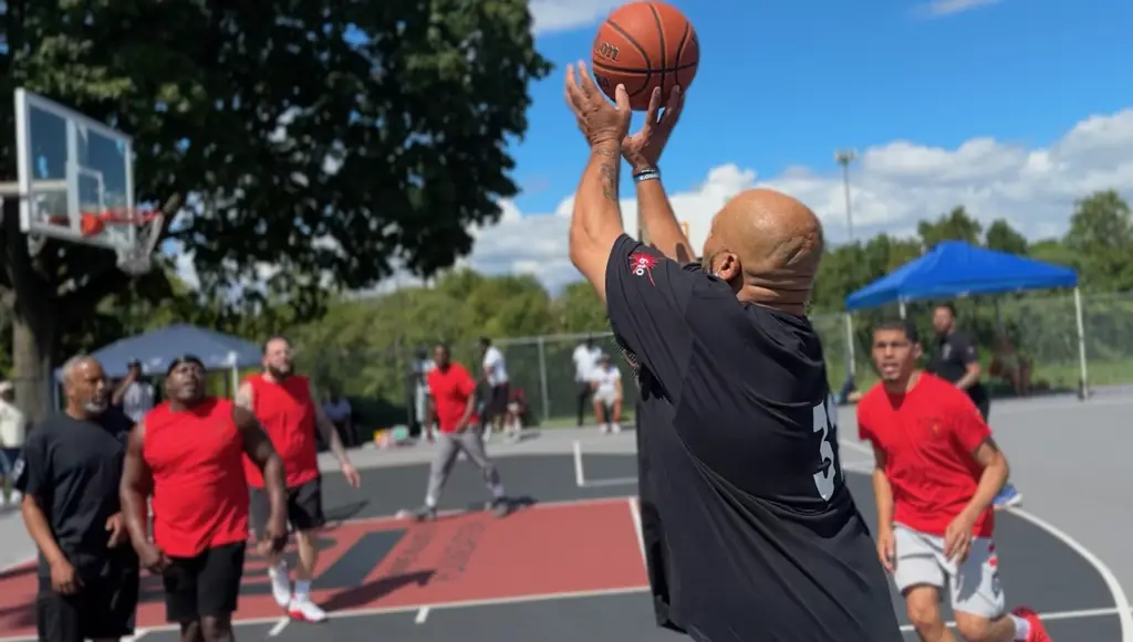 Player releasing a shot at the rim with the ball in the air at the 2nd Annual Legends Only Basketball Tournament, Pixel Perfect Visuals