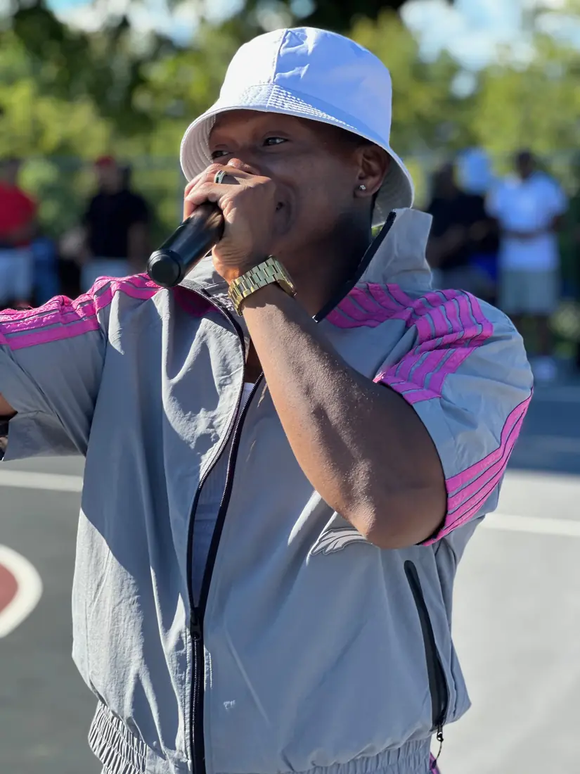 Host on the mic on the outdoor court at the Legends Only basketball tournament, event coverage by Pixel Perfect Visuals