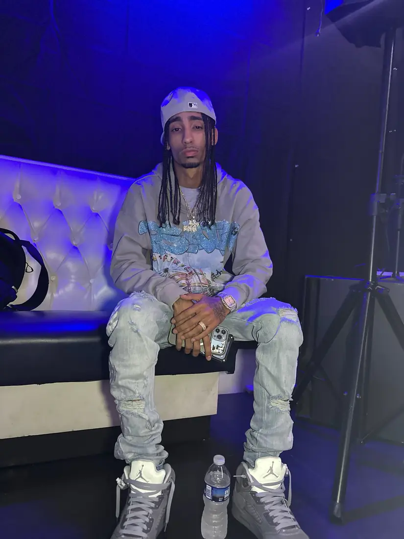 Recording artist seated under blue stage light backstage on The Rookie Of The Year Tour, shot by Pixel Perfect Visuals