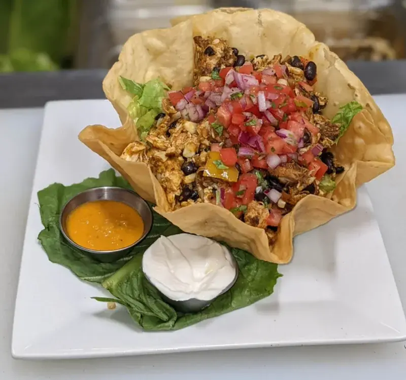 Chicken taco salad in a crisp tortilla bowl with pico de gallo, food photography by chef J.O. King